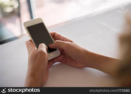 Close up of woman's hands holding cell phone with blank copy spa. Close up of woman's hands holding cell phone with blank copy space screen.