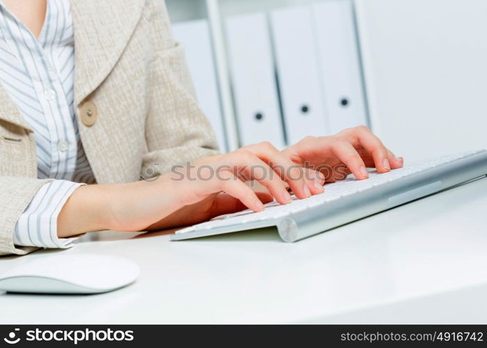 Close up of woman&rsquo;s hands working in office on computer