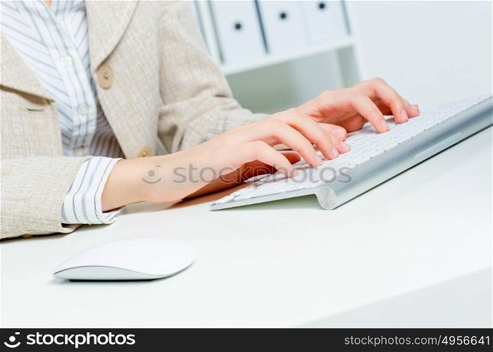 Close up of woman&rsquo;s hands working in office on computer