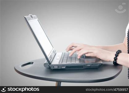 Close up of woman's hands using laptop and splashes out of monitor