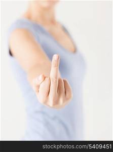 close up of woman showing middle finger