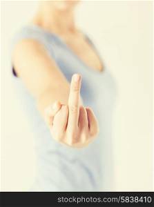 close up of woman showing middle finger