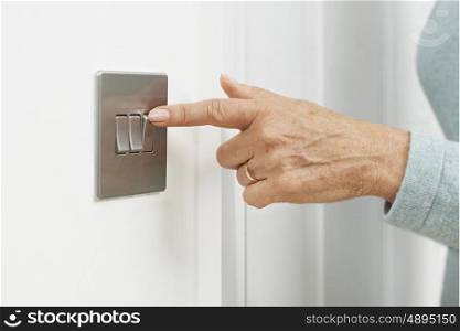 Close Up Of Woman Turning Off Light Switch