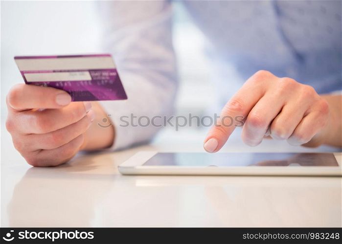 Close Up Of Woman Using Credit Card To Make Purchase On Digital Tablet