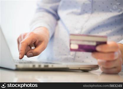 Close Up Of Woman Using Credit Card To Make Purchase On Laptop