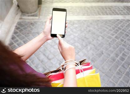 Close-up of woman using her smartphone during shopping