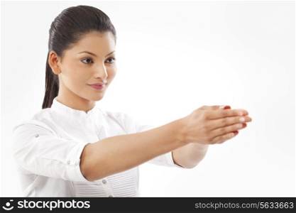 Close-up of woman with hands clasped doing yoga over white background