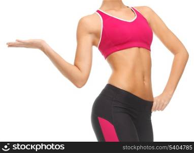 close up of woman with trained abs showing something