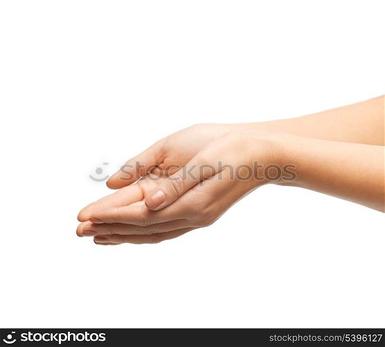 close up of womans cupped hands showing something