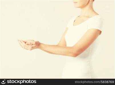 close up of womans cupped hands showing something
