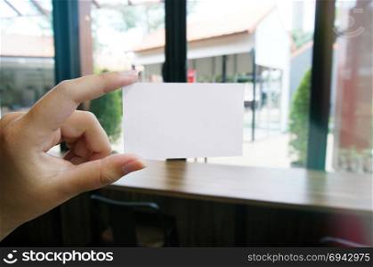 Close up of women hands holding business name card blank copy space screen.