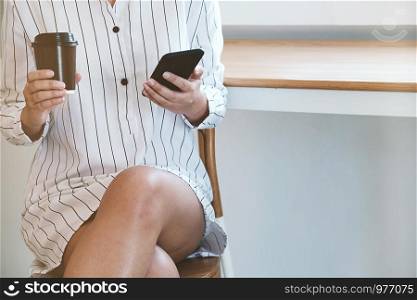 Close up of women's hands holding cell telephone with blank copy space scree for your advertising text message or promotional content, girl watching on mobile phone during coffee break