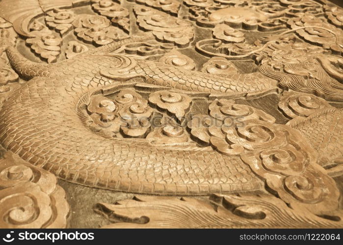 Close up of wood carving of a dragon