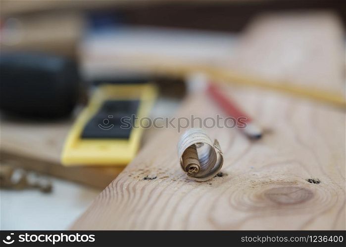 Close up of wood shavings on the carpenter&rsquo;s workbench. DIY woodworking and craftsmanship and handwork concept.