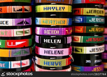Close up of woven cloth name bracelets sold as souvenirs