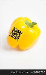 Close-up of yellow bell pepper with bar code over white background