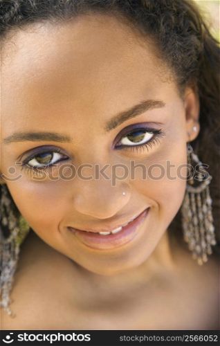 Close-up of young-adult African American woman making eye contact.