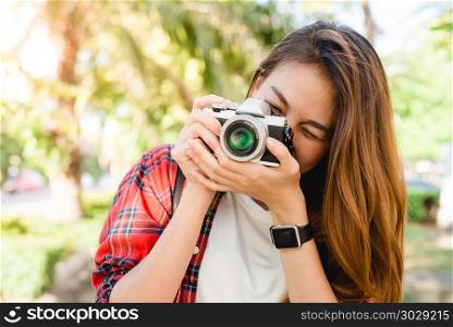 Close up of young Asian woman snap her camera outdoor and enjoye. Close up of young Asian woman snap her camera outdoor and enjoyed her city lifestyle on weekend. Young Woman and her city lifestyle along the street. Outdoor activity and city lifestyle concept.