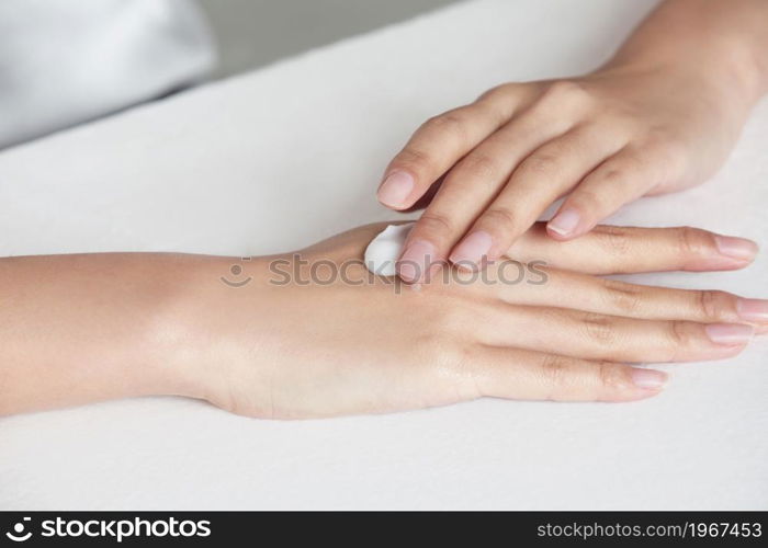 Close-up of young beauty wearing skin care products