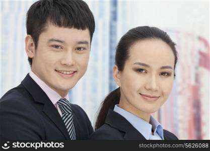 Close-up of young business man and woman, portrait