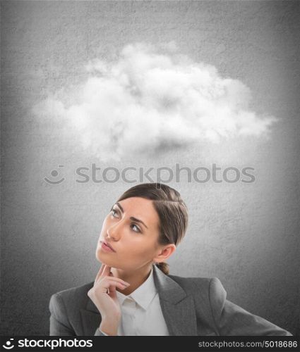 Close up of young business woman looking up for thought bubble above her head with copy space