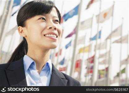 Close- up of young businesswoman standing and smiling