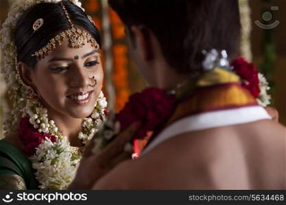 Close-up of young couple during wedding ceremony