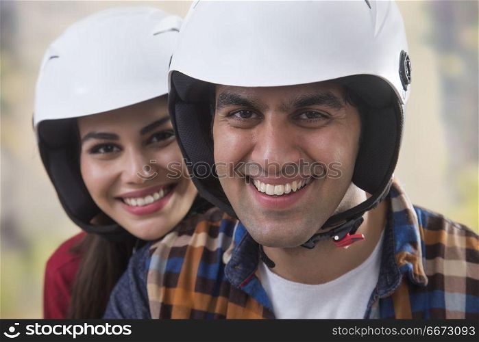 Close up of young couple wearing helmet