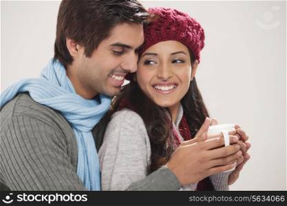 Close-up of young couple with cup of tea