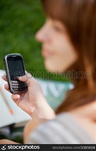 Close-up of young girl using cell phone
