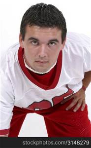 Close up of young man in red and white football jersey. Black hair and hazel eyes.