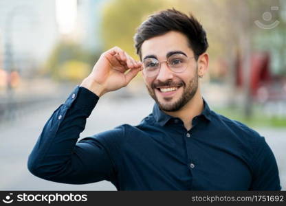 Close-up of young man standing outdoors at the street. Urban and lifestyle concept.