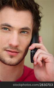 close up of young man with cell phone