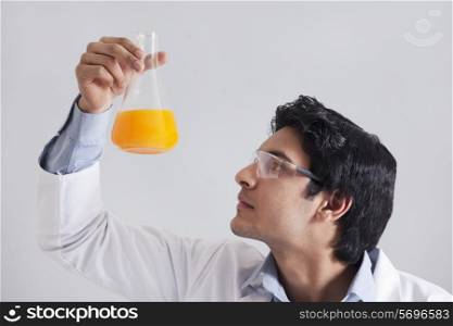 Close-up of young scientist looking at solution