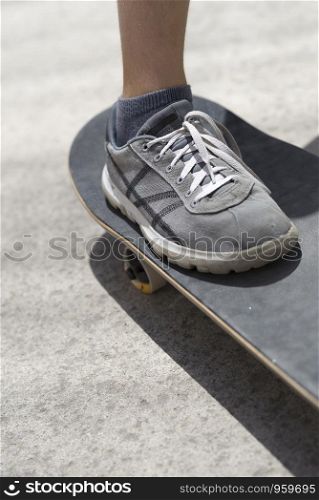 Close up of young skateboarder shoe riding on skateboard