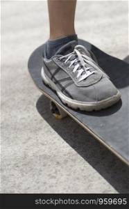 Close up of young skateboarder shoe riding on skateboard