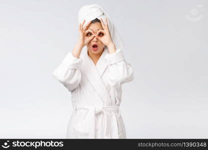 Close up of young smiling woman with finger ok gesture on eyes, isolated on white background.. Close up of young smiling woman with finger ok gesture on eyes, isolated on white background