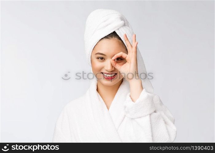 Close up of young smiling woman with finger ok gesture on eyes, isolated on white background.. Close up of young smiling woman with finger ok gesture on eyes, isolated on white background
