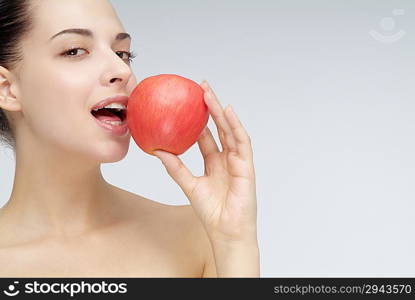 Close-up of young woman holding an apple