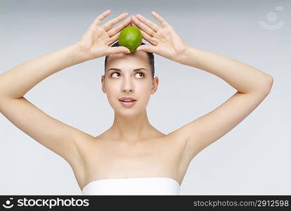 Close-up of young woman holding an orange