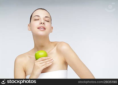 Close-up of young woman holding an orange