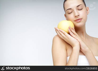 Close-up of young woman holding kind of fruit