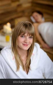 Close -up of young woman in bathrobe sitting at luxury spa