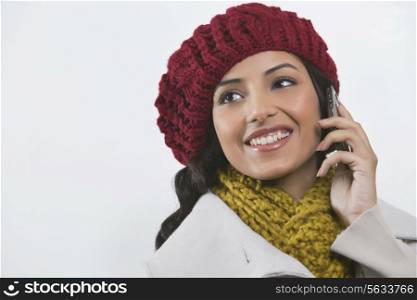 Close-up of young woman looking away while talking on cell phone