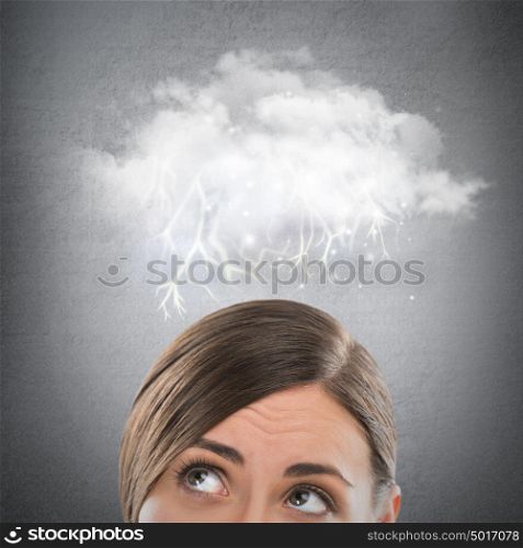 Close up of young woman looking up for thought bubble above her head with copy space