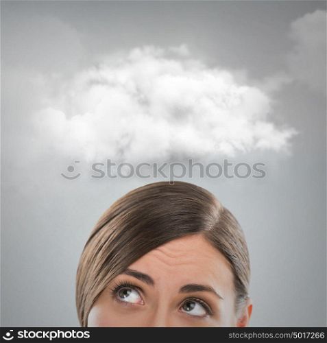 Close up of young woman looking up for thought bubble above her head with copy space