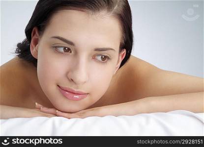 Close-up of young woman lying on front