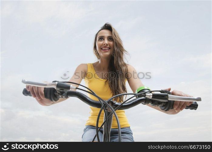 Close-up of young woman riding bicycle