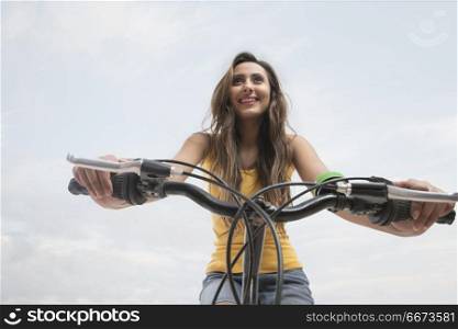 Close-up of young woman riding bicycle