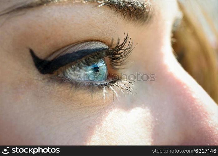 Close-up of young woman&rsquo;s blue eyes with long eyelashes. Make-eye